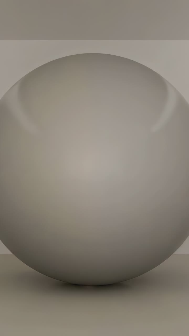 Vidéo verticale : zoom de la caméra révélant une sphère gris mat sur le sol d’un studio, montrant l’ombre portée