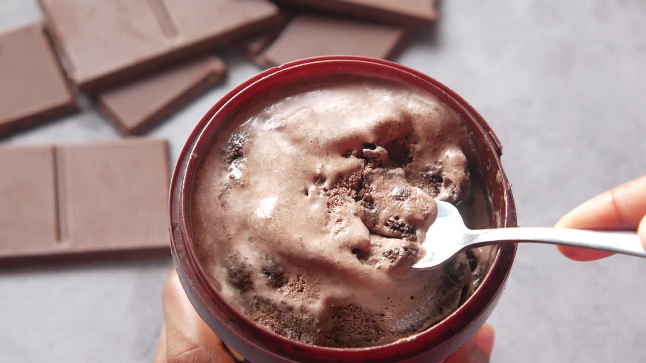 Chocolate Ice Cream in Container with Spoon