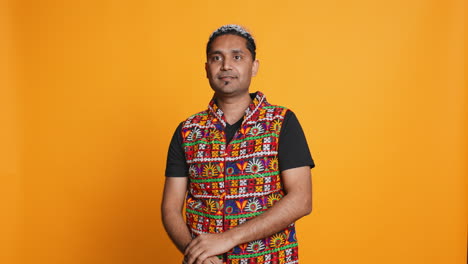 Portrait-of-joyful-man-celebrating,-studio-background