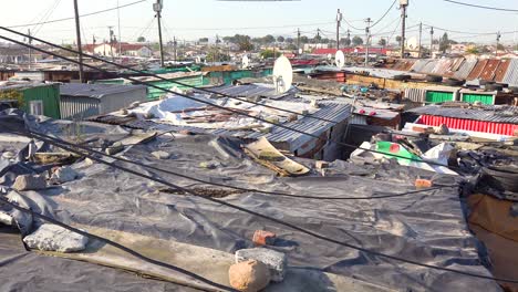 pan across rooftops of a typical township in south africa gugulethu with tin huts poor people and poverty 2