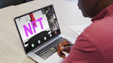 african american businessman using laptop for video call with diverse business colleagues