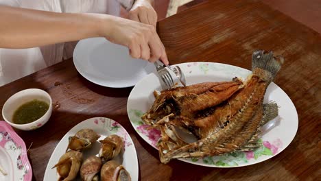 two people enjoying a fish and soup meal together