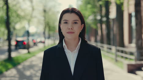 young woman in business attire on city street