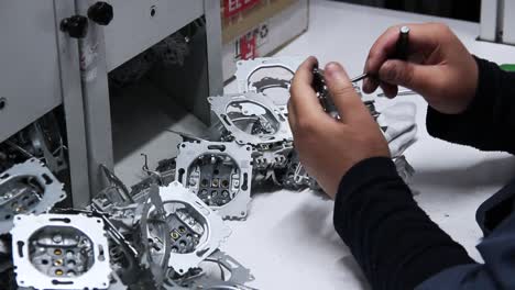 engineer assembling technology widgets, closeup of human hands