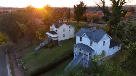 sunset over traditional homes in a quiet, green neighborhood