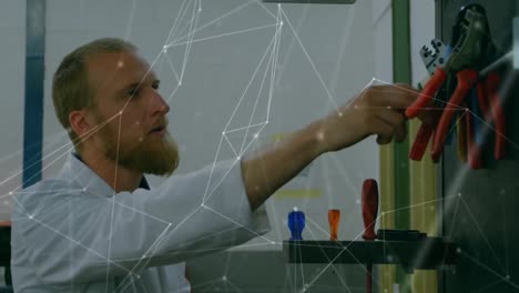 animation of network of connections over caucasian man working in computer laboratory