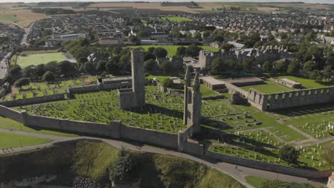 Aerial-view-orbiting-the-St-Andrews-Cathedral-and-cemetery-grounds-in-St-Andrews,-Scotland,-UK