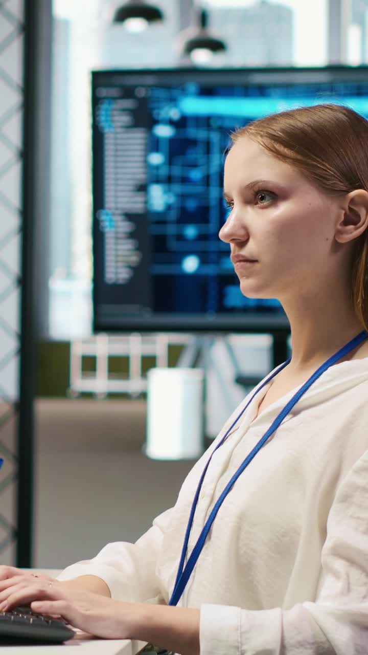 Vertical video Female technician coding with AI language model assistance in startup office