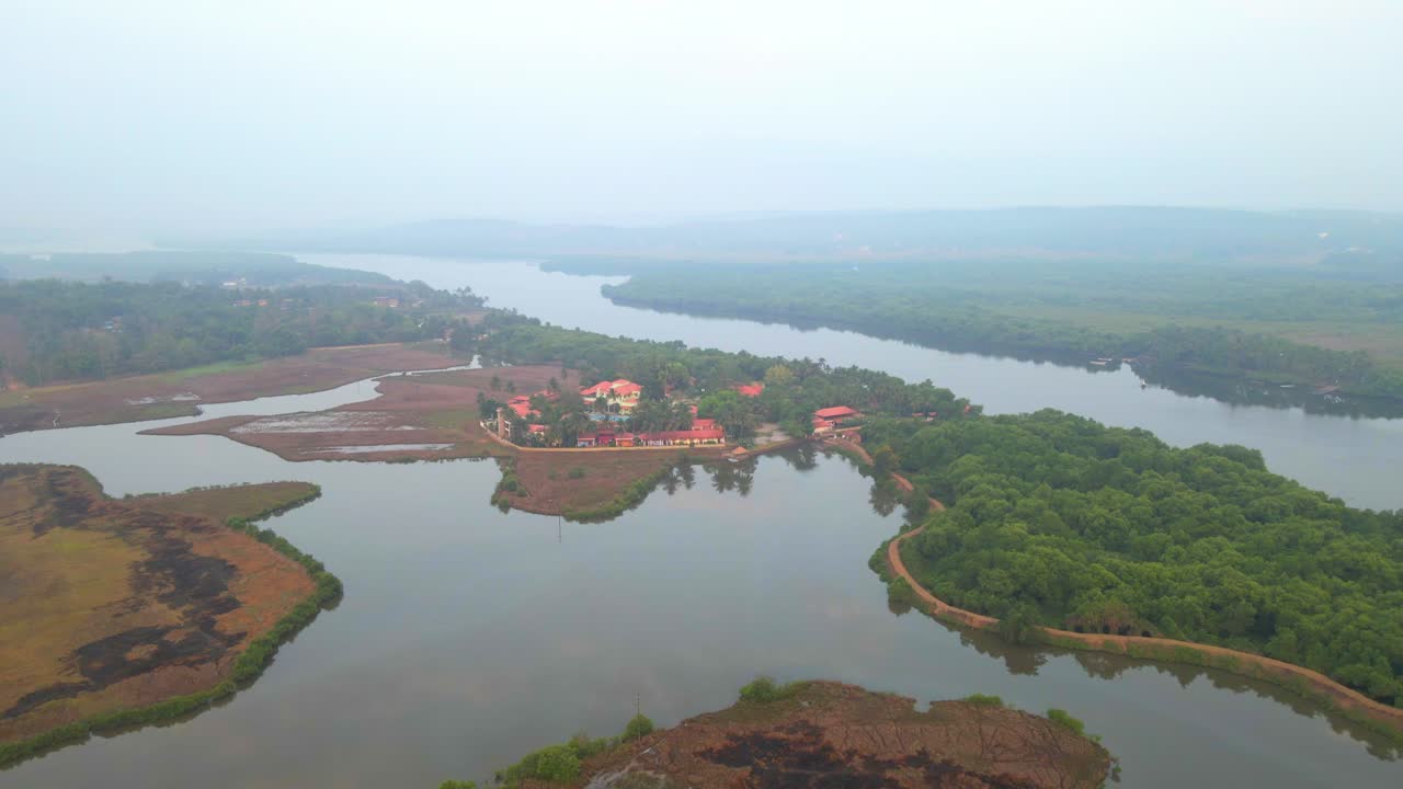 goa divar island drone passing from coconut trees vacation Mercure Goa Devaaya sky reflection on water still water