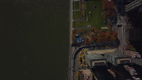 Aerial-birds-eye-overhead-top-down-view-of-river-waterfront-and-busy-road-tunnel-under-United-Nations-building-complex.-Manhattan,-New-York-City,-USA