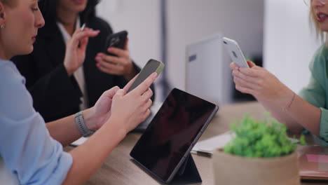 three women holding phones, browsing social media