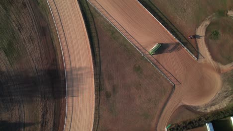 Horse-race-track,-overhead-drone-shot-with-jockeys-training