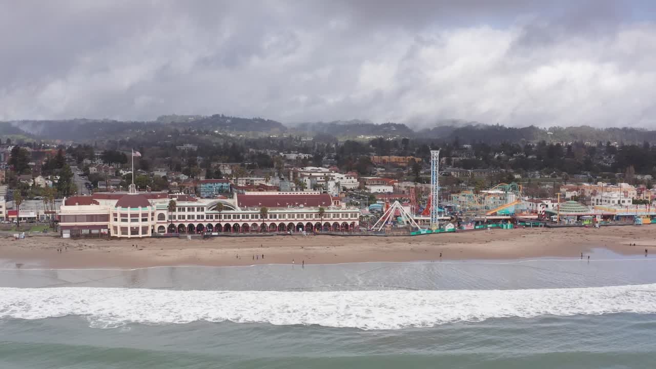 Wide aerial panning shot of the historic Coconut Grove Ballroom building at the Santa Cruz Beach Boardwalk in Santa Cruz, California. 4K