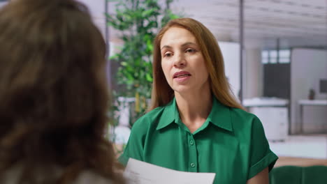 hr recruiter examines a candidate resume during a formal job interview