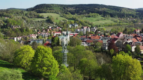 modern 5g telecommunications bts mast in an old european town surrounded by green hills