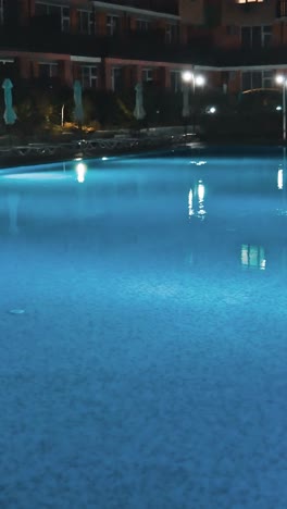 swimming pool at a luxury, tropical resort at night