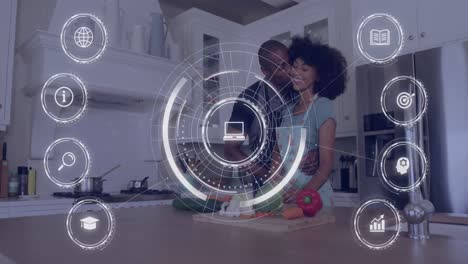 Animation-of-african-american-couple-in-love-in-kitchen-and-icons-with-data-processing