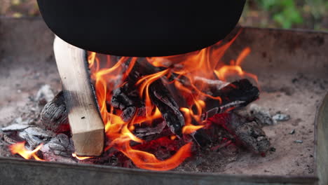 slow motion of outdoor wood cooking fire heating cauldron, or bogrács