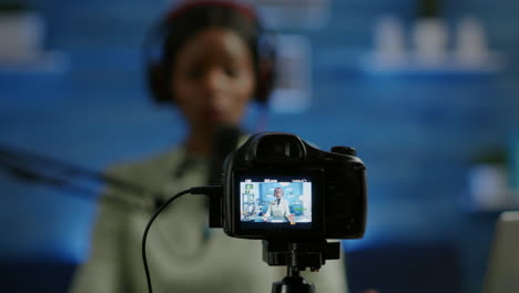 close up of professional camera sitting in front of dslr recording