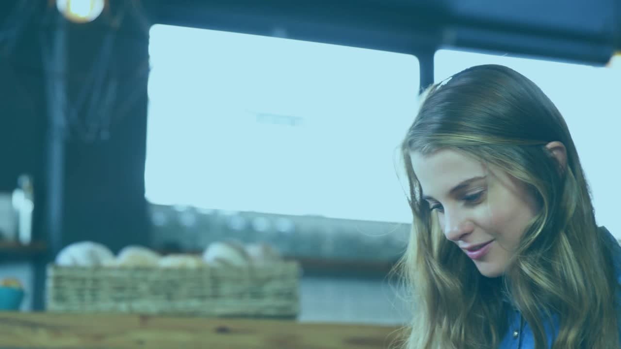 Woman tapping smartphone at cafe, revealing AR icons and numbers showing app data on cup