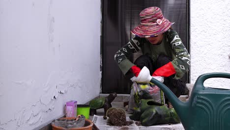 woman transplanting plants into pots, a moment of gardening and nature connection