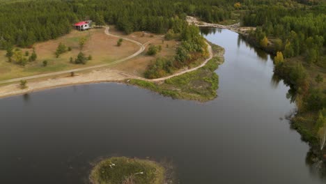 A-small-island-in-a-man-made-lake-in-front-of-a-remote-cabin