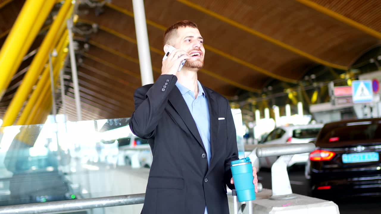 Man talking on phone in airport