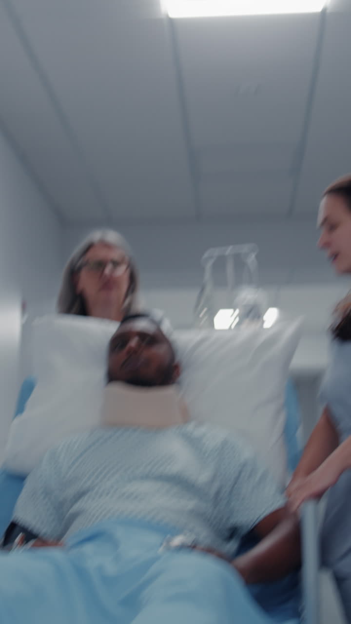 Mature doctor and nurse transport patient to hospi 4k 2025 08 04 23 58 25 utc.mov | african american, care, catheter, caucasian