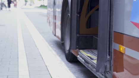 blind man getting on the bus with help from his stick and from a woman - concept of public transport for all