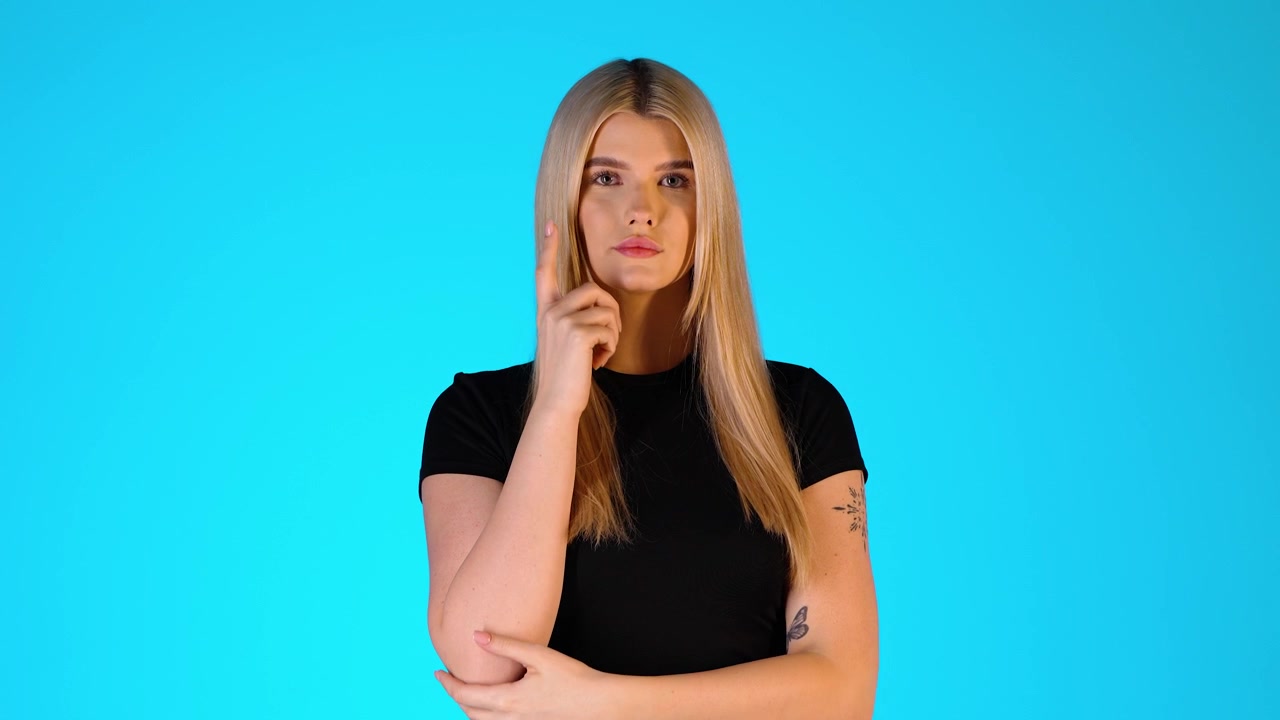 Young Blonde Woman Shrugging Gesture, Thinking and Doubtful, Colorful Studio Portrait