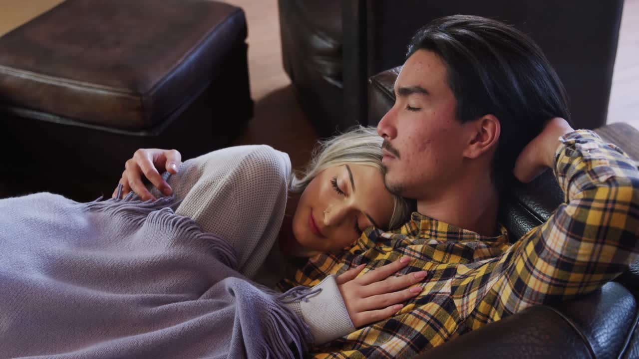 Happy couple taking a nap on the couch