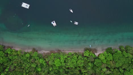 boats anchored in the sea, in the beautiful jicaro beach in costa rica