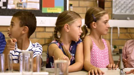 school kids interacting with each other in laboratory