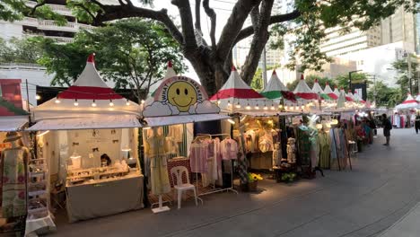 shoppers browse stalls at an evening street market