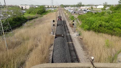 coal train transporting resources in cargo, aerial follow shot