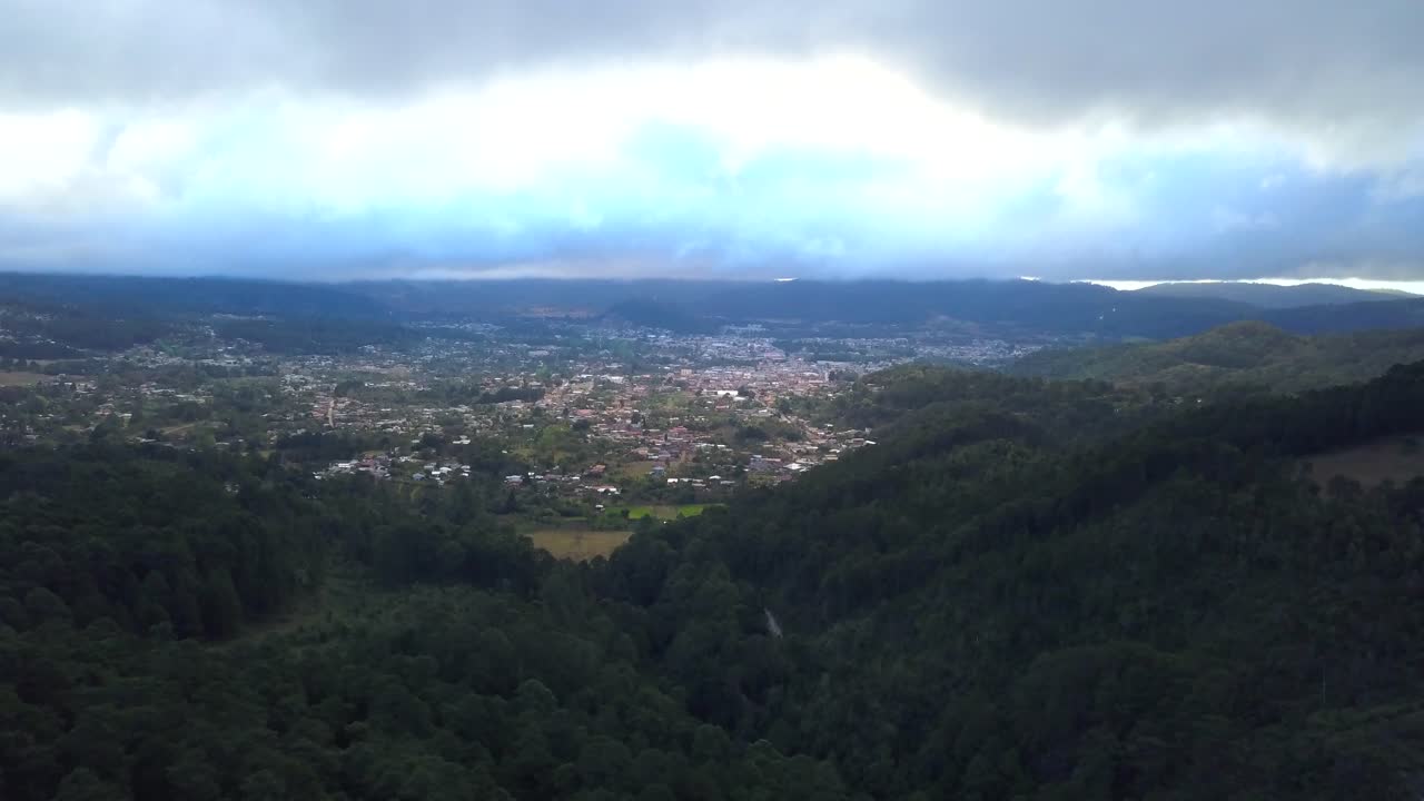 Drone shot of a city in the middle of the mountain
