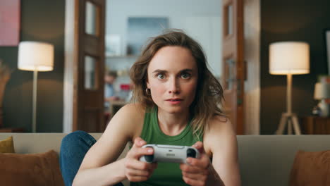 pov focused player gaming controller home. young woman holding joystick playing