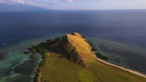 kenawa island with beautiful hill in indonesia - aerial shot