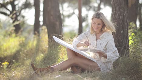 artist girl paints a picture outdoors