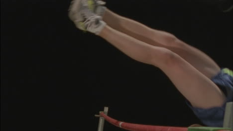 male athlete competes in pole vaulting