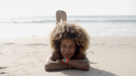 Woman-In-A-Swimsuit-Relaxing-On-The-Sand