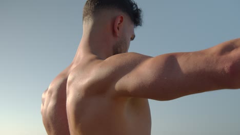 muscular man exercising with dumbbells