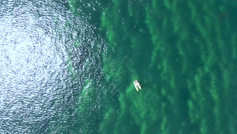 Top-view-of-two-canoes-adrift-in-the-Atlantic-ocean-at-noon