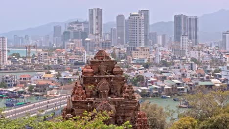 This-footage-captures-the-iconic-Ponagar-Temple-set-against-the-backdrop-of-the-bustling-city-of-Nha-Trang,-Vietnam