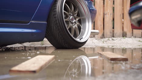 low-rider car in a puddle