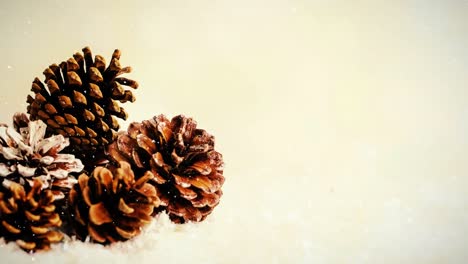 Fir-cones-on-wood-combined-with-falling-snow