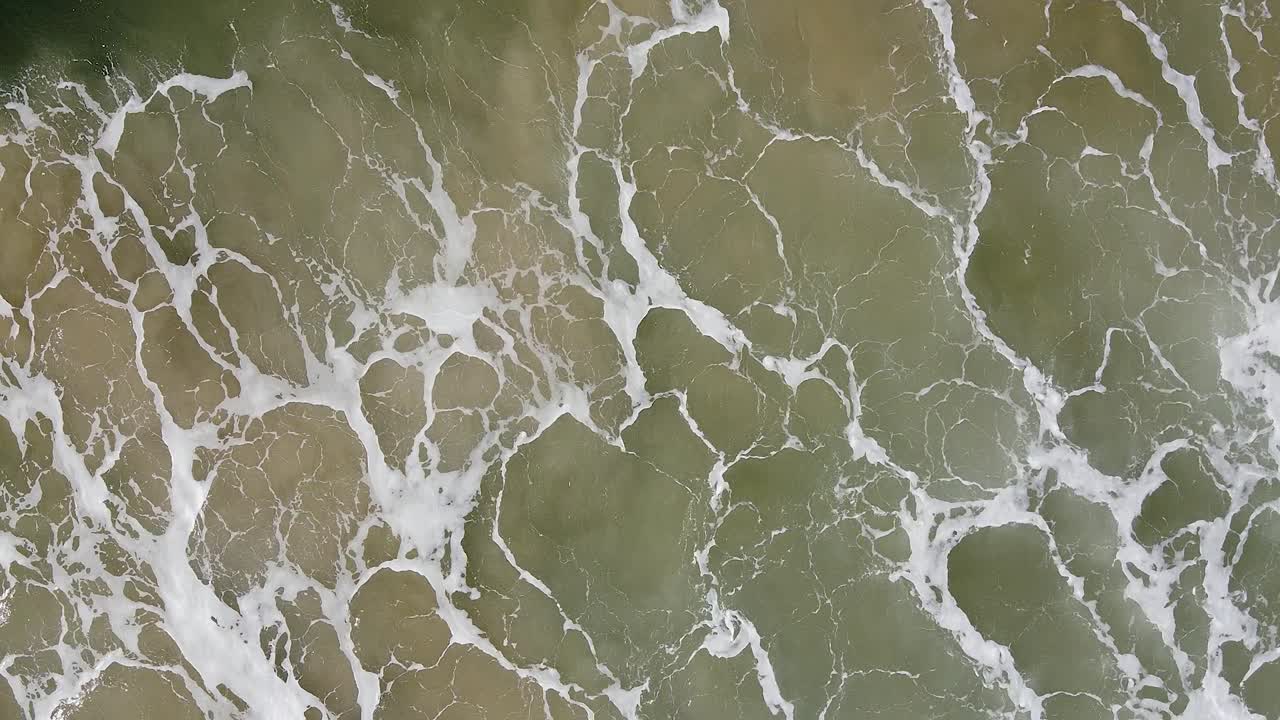 Aerial View of Ocean Waves Crashing on the Shore