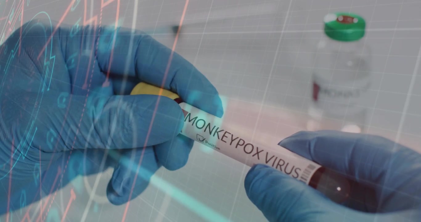 Labtech gloved hands grabbing and rotating sample tube, overlay highlighting MONKEYPOX for ID