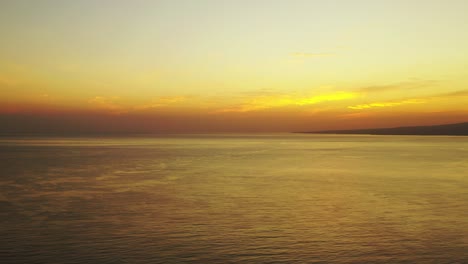 golden sunset with yellow clouds and bright sky reflecting on peaceful endless sea surface in cambodia, copy space