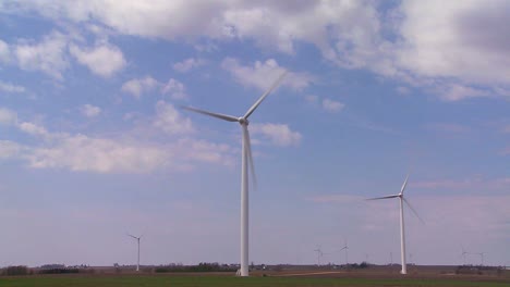 giant windmills in the distance generate power behind farms in the american midwest 6